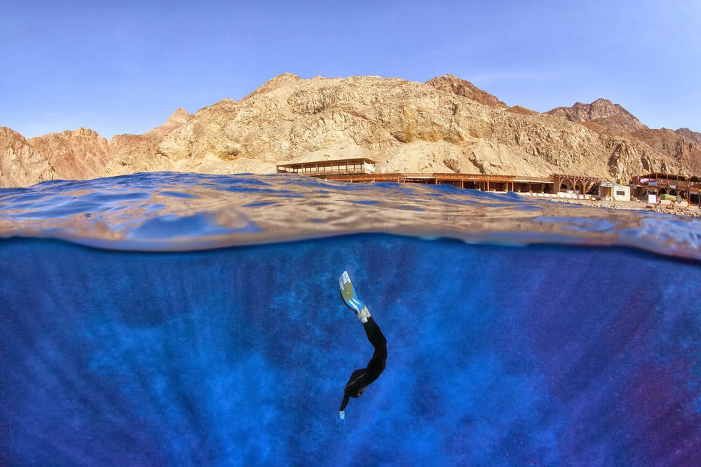 A freediver diving into the world renowned 'Blue Hole' in Dahab, Egypt.